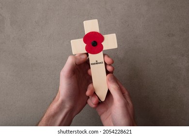 A Red Remembrance Poppy On A Wooden Cross. Military Remembrance Day Concept