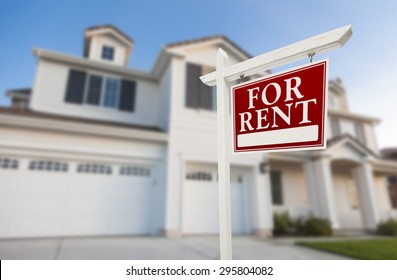 Red For Rent Real Estate Sign in Front of Beautiful House. - Shutterstock ID 295804082