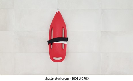 A Red Rescue Buoy On A White Tiled Wall 