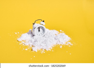 Red Retro Alarm Clock With Snow On Yellow Background. Creative Christmas Or New Year Concept. 