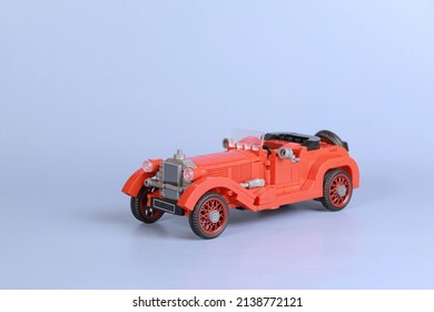 Red retro car from the constructor, auto insurance. Car on a blue background
