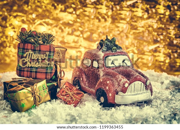  red\
retro toy car with Christmas tree delivering Christmas New Year\
gifts. Feast of the Nativity of Christ; New\
Year\
\
