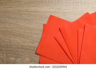 Red Reusable Beeswax Food Wraps On Wooden Table, Top View. Space For Text