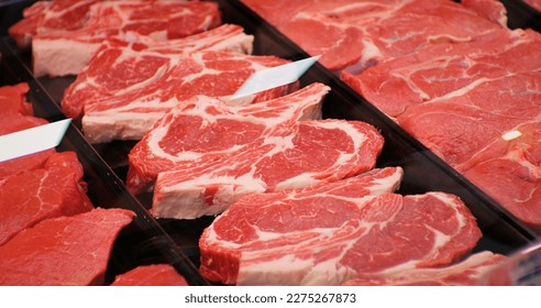 Red rib eye meat for sale in meat department in a shop. Raw fresh meat ribeye for steak perfectly arranged in trays. - Powered by Shutterstock