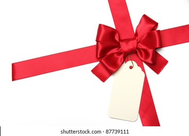 Red Ribbon Bow With Blank Gift Tag.Isolated On White.