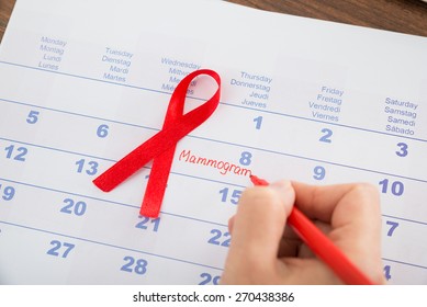 Red Ribbon With Doctor Appointment For Mammogram On A Calendar