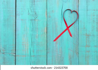 Red Ribbon Heart On Antique Teal Blue Weathered Wood Background