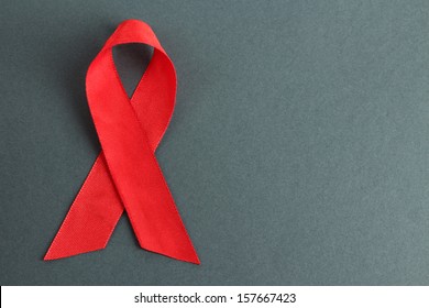 Red ribbon HIV, AIDS on gray background