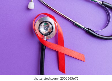 Red ribbon, stethoscope on the purple background. Woman breast cancer concept. Top view. - Powered by Shutterstock