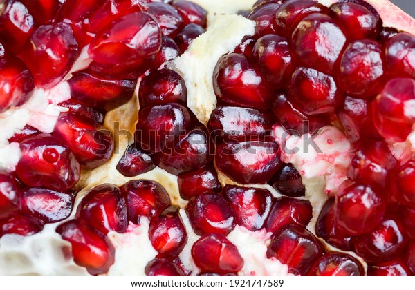 red and ripe fruit pomegranate with
red grains, delicious and healthy pomegranate divided into several
parts with red seeds, fresh pomegranate
closeup