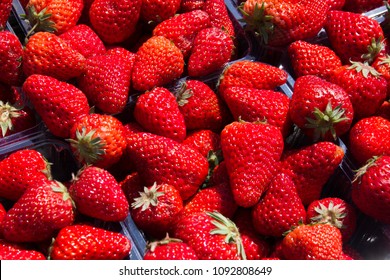 red ripe strawberries in a box on the market