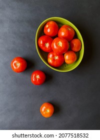 Red, ripe tomatoes on a dark background, Fresh tomatoes in the green bowl, Top view
 - Shutterstock ID 2077518532