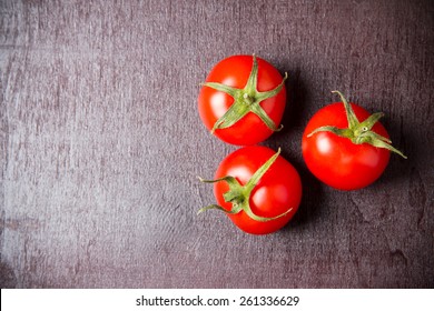 Red ripe tomatoes on a wooden surface. Top view - Powered by Shutterstock