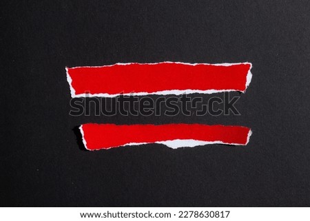 Red ripped paper pieces isolated on a black background