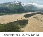 Red River flowing from Red Glacier on Mount Iliamna Volcano in Lake Clark National Park and Preserve in Alaska. Braided river and delta rich with sediment drains into Cook Inlet.. Chigmit Mountains.