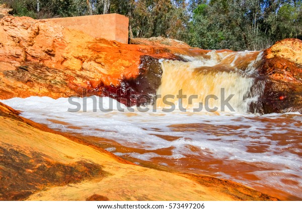 Red river\
waterfall, Red tinted river by copper on the ground. Water used in\
life study for life detection in\
Mars