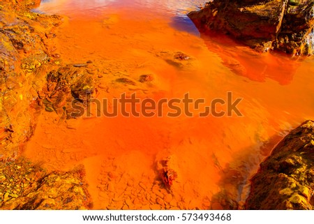 Red river with red - yellow - orange acid stones. Red tinted river by copper on the ground. Water used in life study for life detection in Mars Stock photo © 