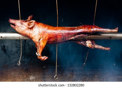 Red roasted pig on a traditional spit