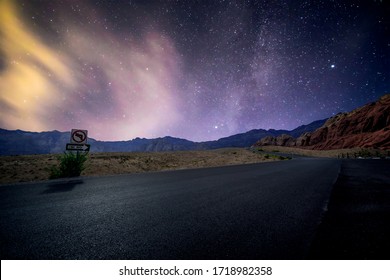 Red Rock Canyon in Las Vegas, Nevada, USA under a star lit sky glowing over the asphalt scenic byway. - Shutterstock ID 1718982358
