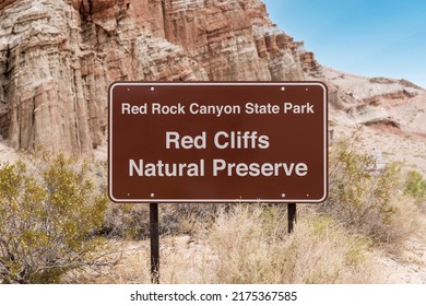 Red Rock Canyon State Park Red Cliffs Natural Preserve sign in the Mojave desert area of California.   - Shutterstock ID 2175367585