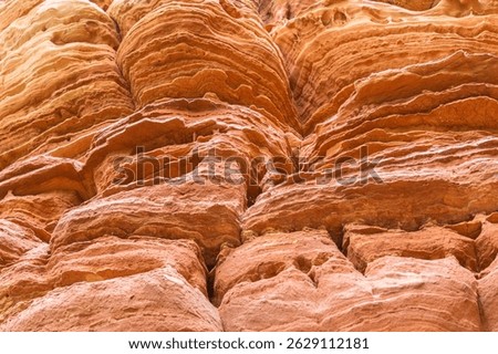 Red rock formations a close-up of the bizarre structure in reserve Altschlossfelsen in the Saarland region of Germany. The stones have a bright red and orange color and abstract form.