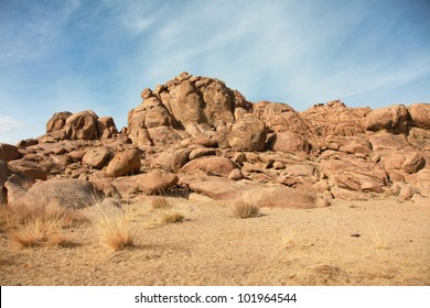 Red Rocks In The Barren Sands Of The Gobi Desert