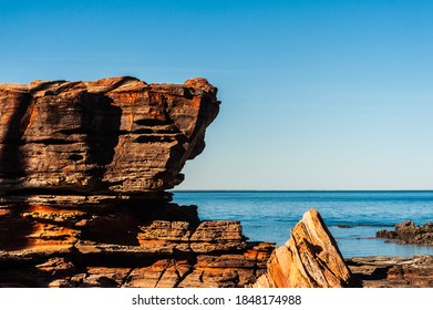 Red Rocks Overlooking Blue Sea Of Roebuck Bay