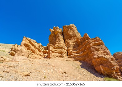 Red rocky mountains Red rocks pass by ancient rocky formations, through ridges and rivers traveling between rock formations of the Charyn canyon Kazakhstan. Replica of the United States Grand Canyon - Powered by Shutterstock