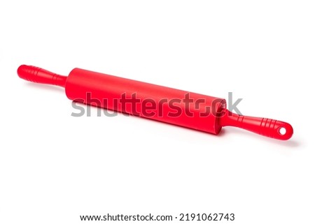 red rolling pin with silicone coating for rolling dough on a white background. accessories for professional confectioners and amateurs.