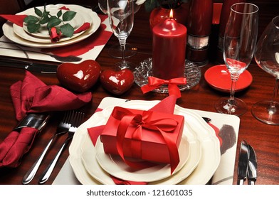 Red romantic Valentine dinner for two table setting.
