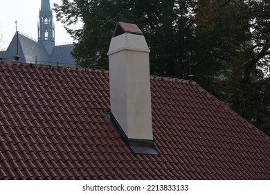 Red Roof Tiles With Red Brick Chimney On Tree Background.