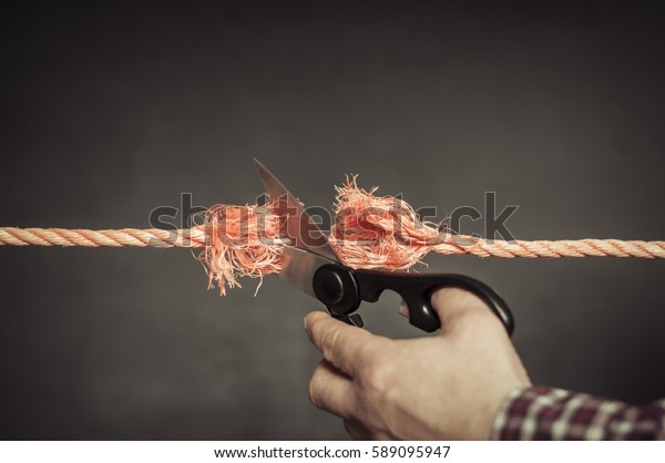 Red rope is\
cut with scissors./Red rope is cut\
up