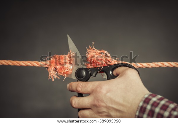 Red rope is\
cut with scissors./Red rope is cut\
up