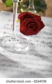 red rose on a sheet of notes close up shoot