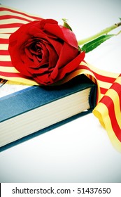 a red rose with the senyera and a book, a catalan tradition for the roses day