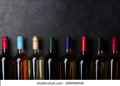 Red, rose and white wine bottles on stone table. Top view with copy space - Powered by Shutterstock