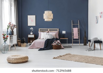 Red Roses In Blue Glass Vase Next To White Wooden Shelf With Designed Vases In Colorful Bedroom 