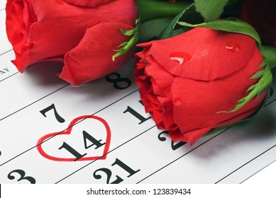 red roses lay on the calendar with the date of February 14 Valentine's day - Powered by Shutterstock