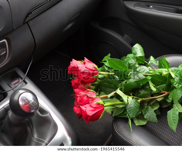 Red roses on the seat of the car. Building\
Relationship Concept.