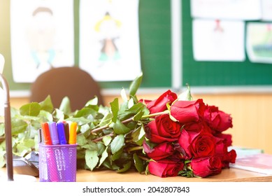 Red Roses On Teacher's Desk In Class.