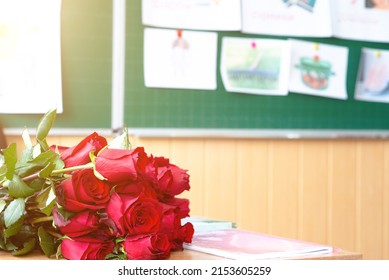 Red Roses On Teacher's Desk In Class.