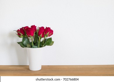 Red Roses In Vase  On Table