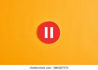 Red round circle with a pause button or icon against yellow background. - Shutterstock ID 1881827575