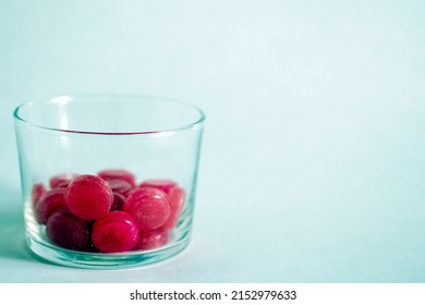 Red Round Pills For Throat Treatment In A Pill Box Shifted To The Left.