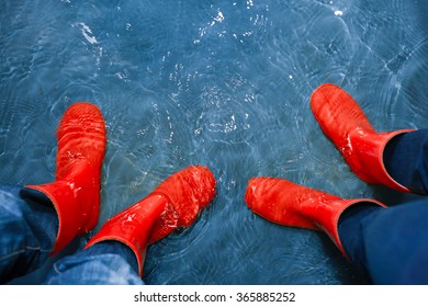 Red Rubber Boots In The Water