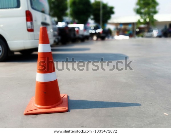 Red\
rubber cone and concrete road floor in gas\
station