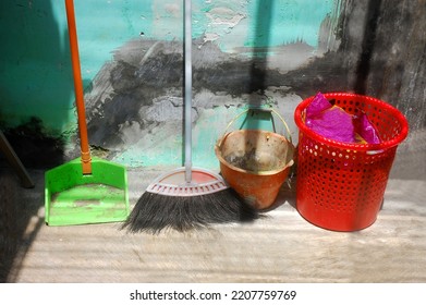 A Red Rubbish Bin Or Trash Bin, Side By Side With Broom And Dustpan Garbage. Clean And Eco Green Concept Nature. Must Be Available At Home