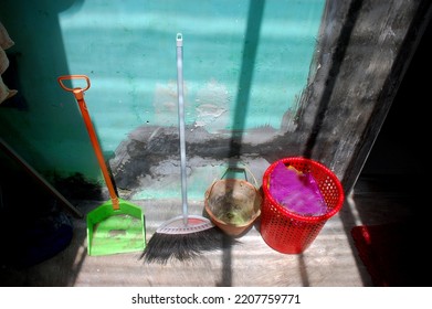 A Red Rubbish Bin Or Trash Bin, Side By Side With Broom And Dustpan Garbage. Clean And Eco Green Concept Nature. Must Be Available At Home