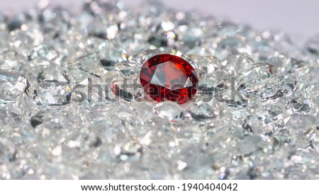 Red ruby diamonds are placed on a pile of white diamonds And keep turning. video 4k resolution shoot in studio

