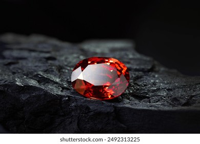 Red Ruby gemstone on stone background, close up shot